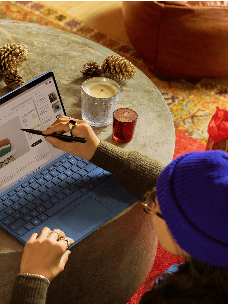 A person, seen from an overhead angle, is working on a laptop at a table. They are wearing a blue beanie and dark-rimmed glasses. The words "FOR FREELANCERS" are displayed prominently at the top of the image in white text, and a green circle with a white plus sign is in the bottom right corner.